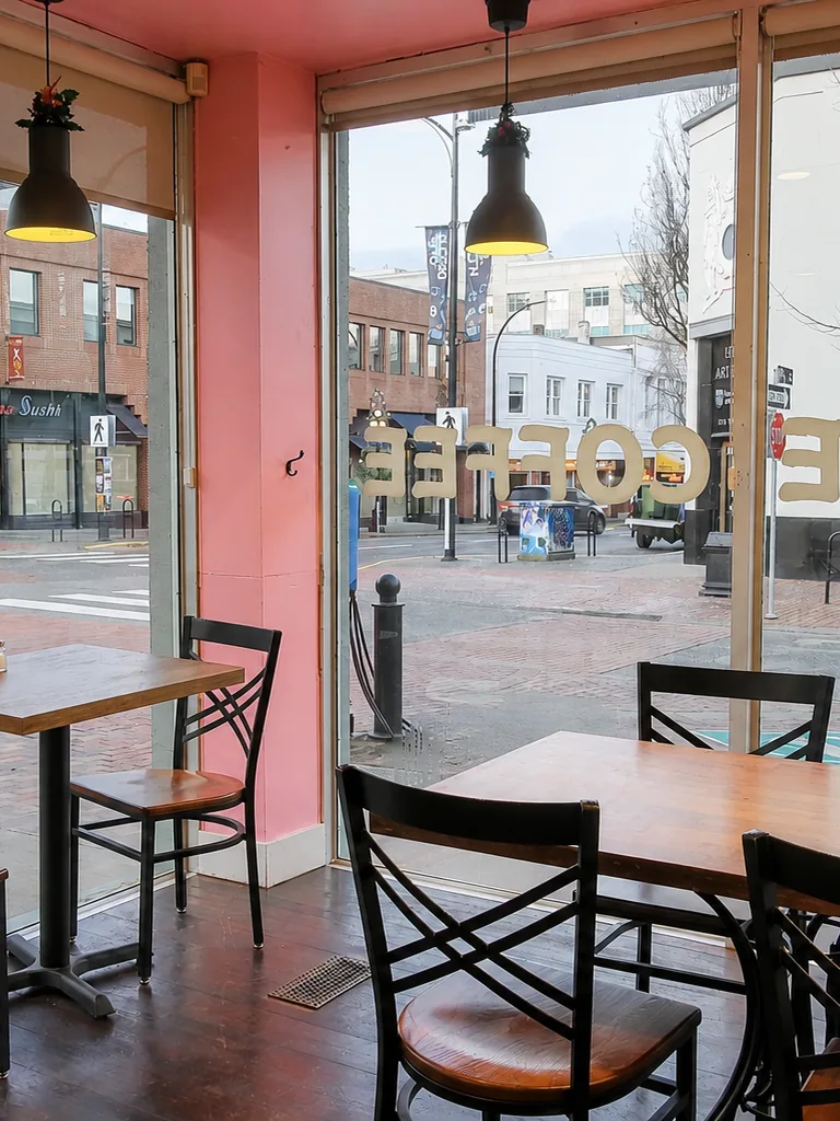 Sunlit tables and chairs inside Wonderffle Cafe