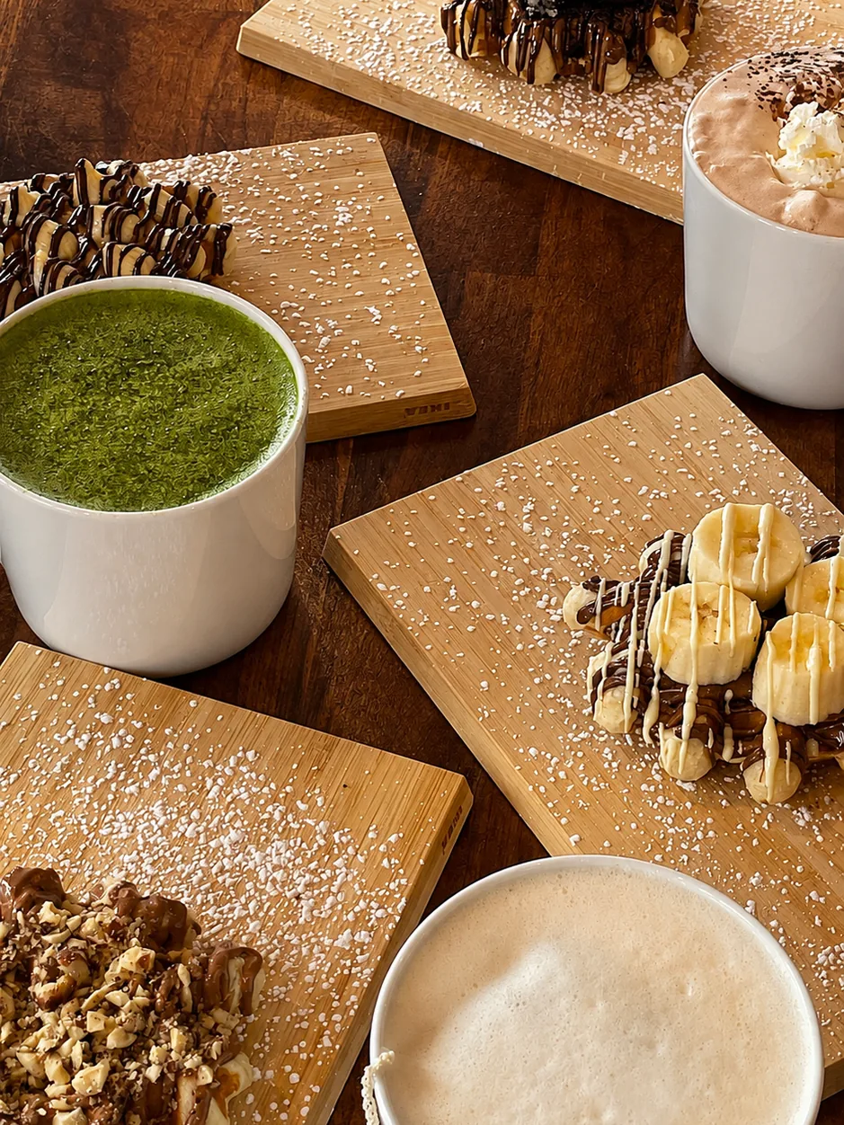 Matcha and coffee alongside Belgian waffles on a cafe table